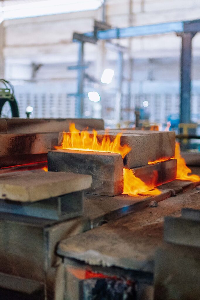 Flames inside an industrial furnace on a factory floor
